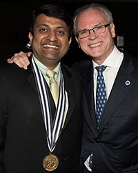 Dr Harish Hosalkar being congratulated by Dr Gerald Williams,